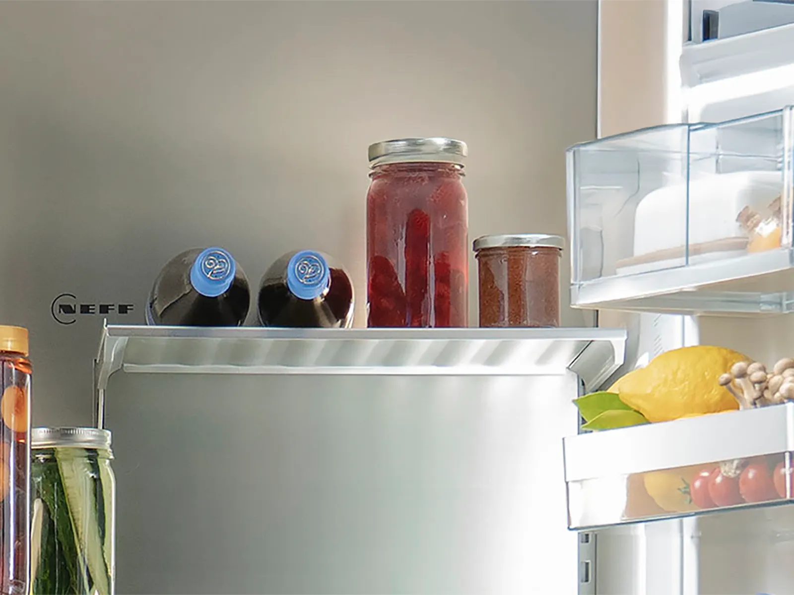 Interior of NEFF MultiDoor fridge with bottles and jars neatly stored on a Bottle Flex Rack.