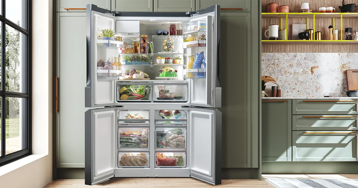 Open multi-door refrigerator in a modern kitchen, neatly stocked with fresh food and drinks. 