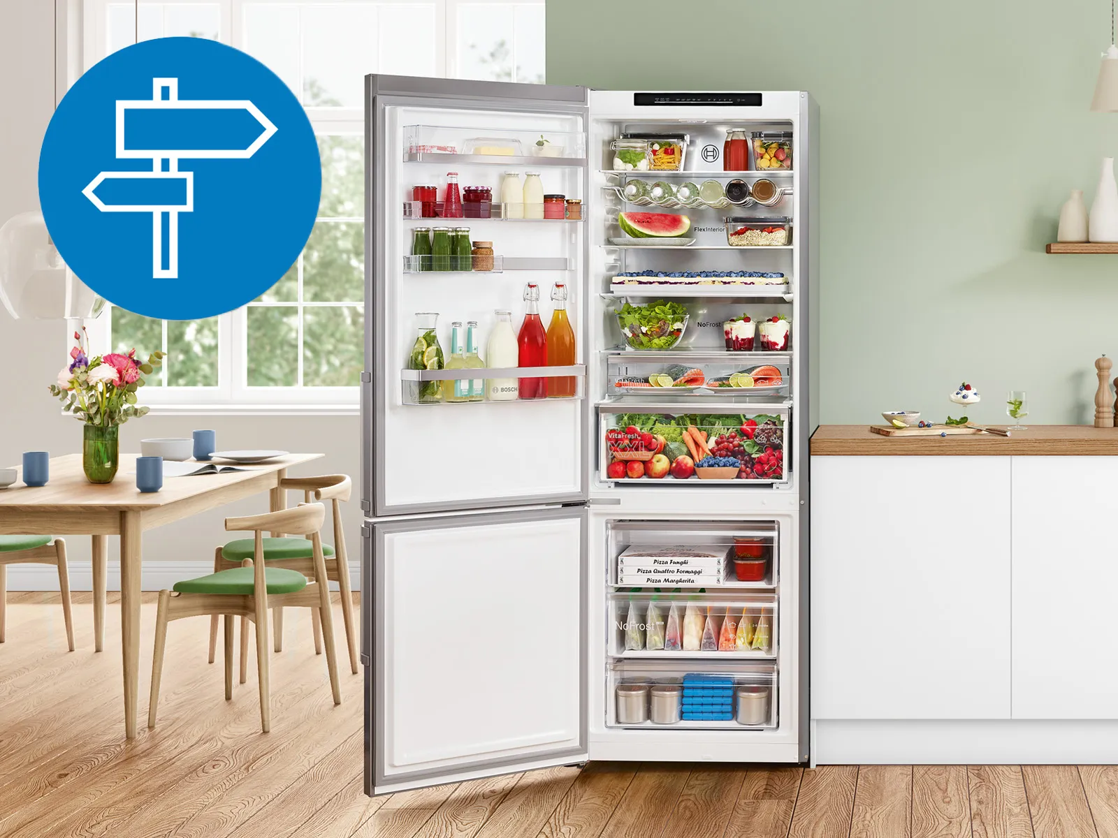 A stainless steel, freestanding Bosch fridge-freezer in a bright, modern kitchen. The kitchen has white cabinets, a light wood floor, and a dining area visible in the background. A blue circular icon with a white directional sign is overlaid on the top left.