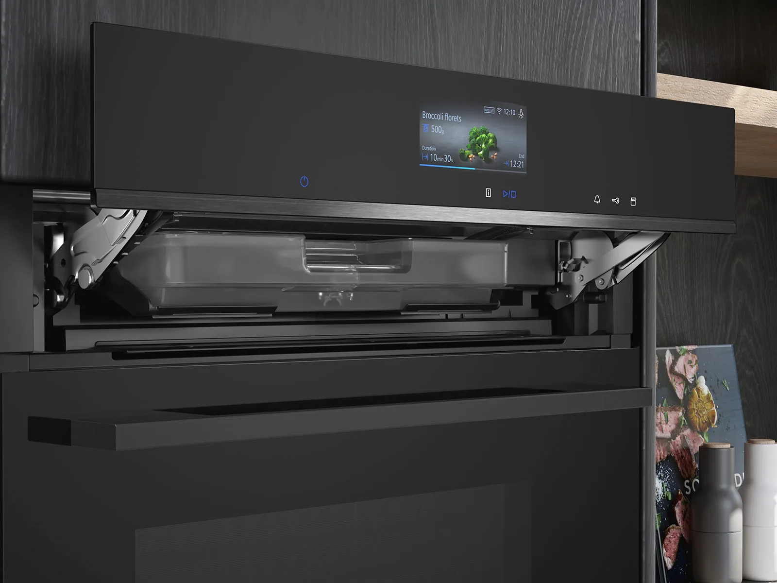 En sort kombi-dampovne er indbygget i et højskab og betjeningspanelet står åbent så man kan se vandbeholderen til dampfunktionerne.