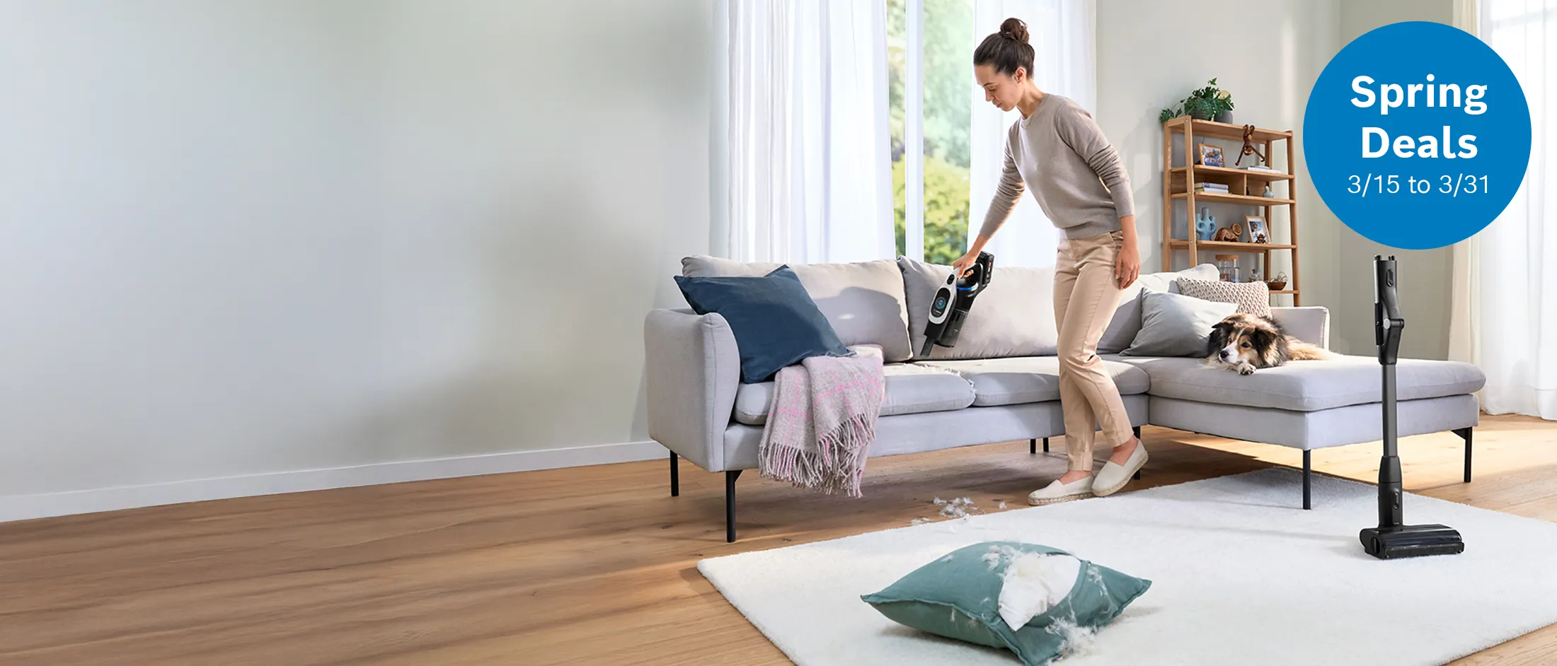 Woman cleaning her living room with bosch stick vacuum