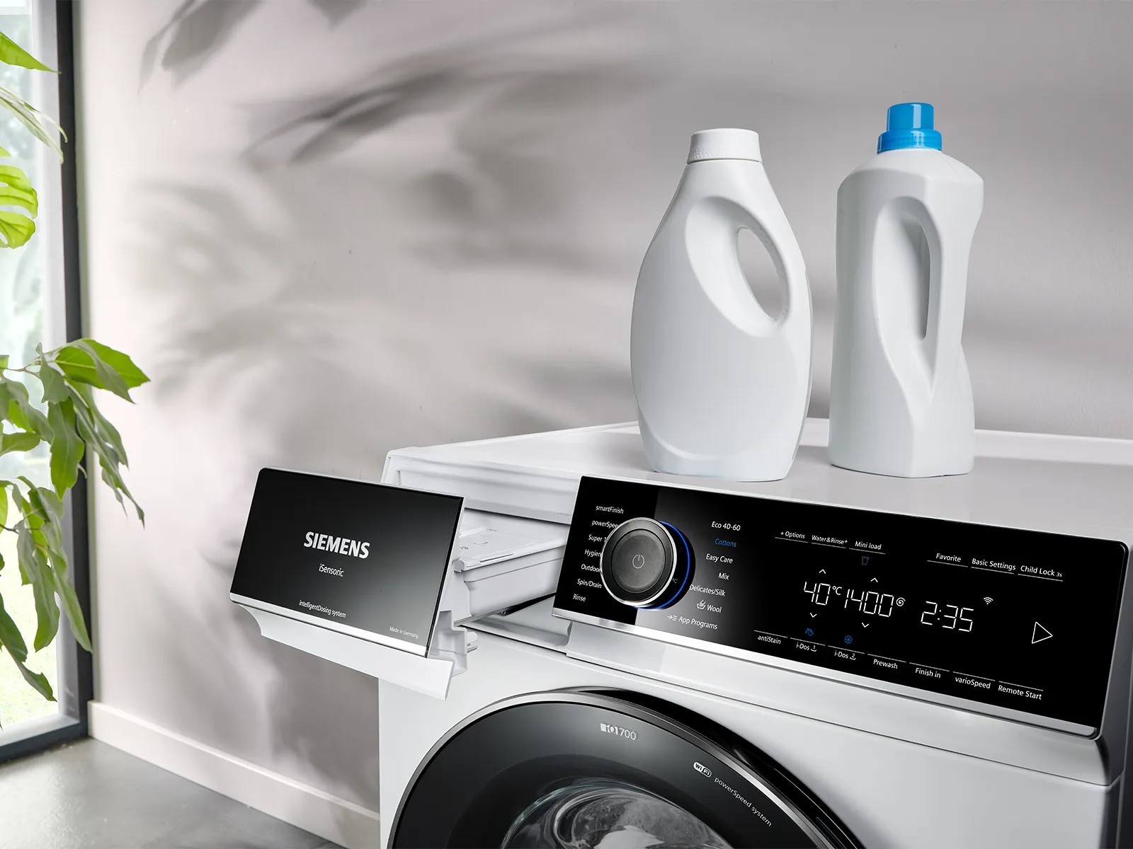 Person pouring detergent into a washing machine.