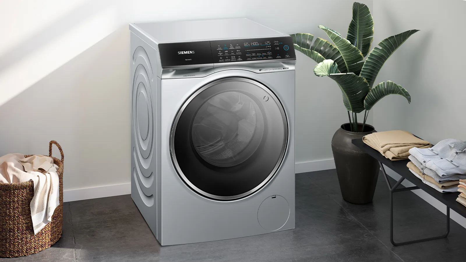 Modern white washing machine with digital display and control panel.