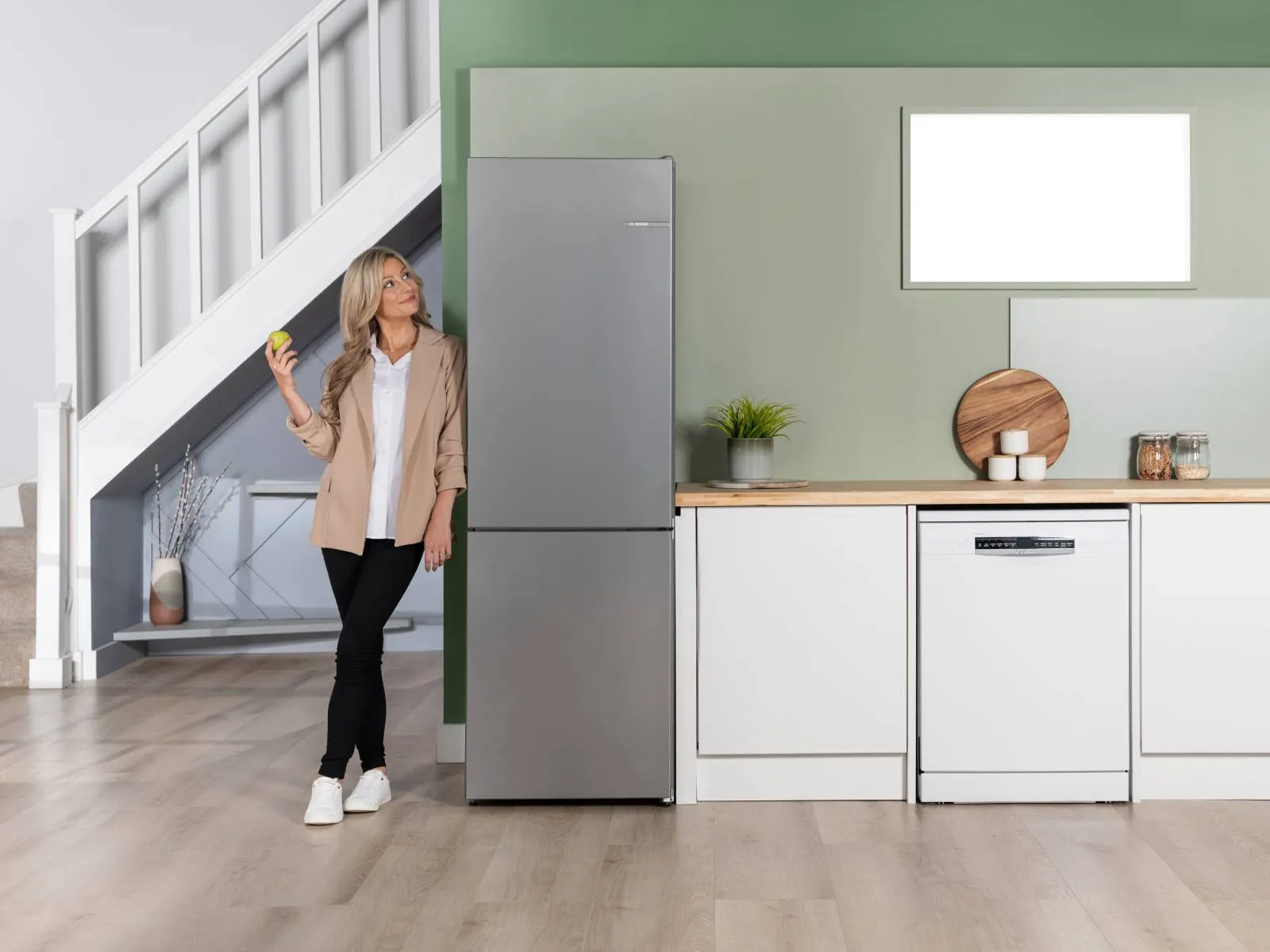A modern refrigerator with a stainless steel finish, showcasing neatly organized food items and fresh produce inside.
