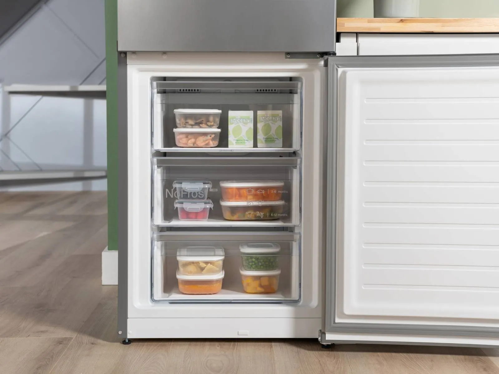 White freestanding appliance with door slightly open to show flexible storage options.
