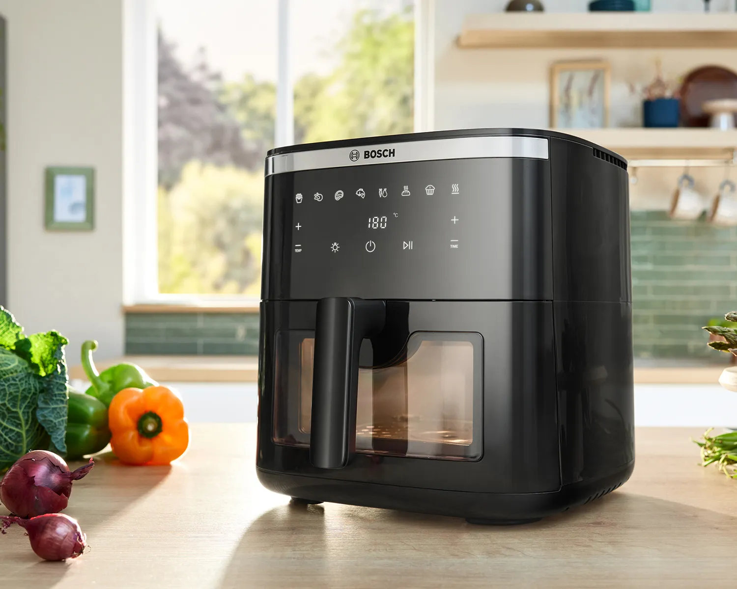 A Bosch Air Fryer Series 6 is positioned on a bright kitchen counter, viewed from the front, showcasing its modern design.