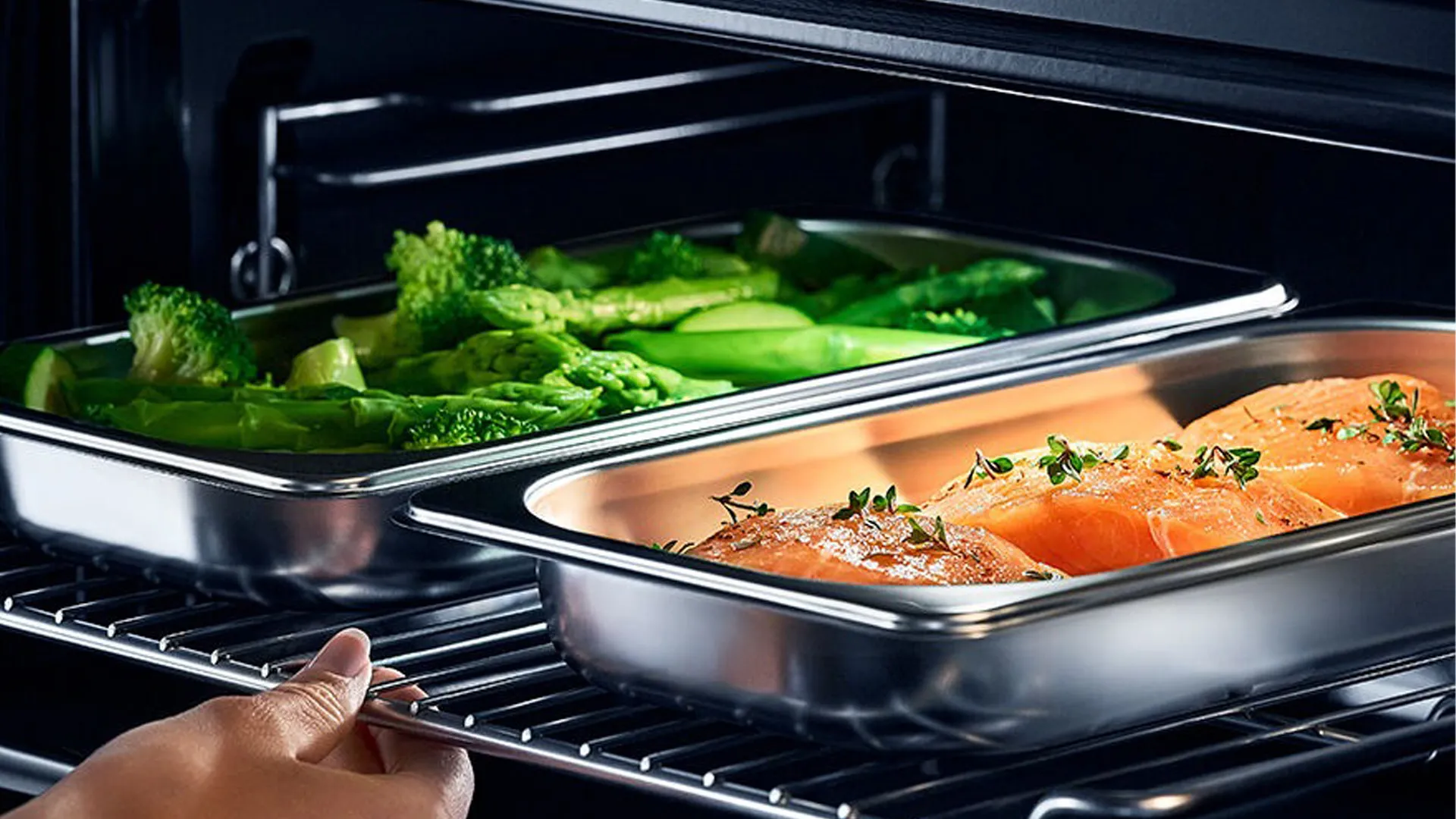 Fish and vegetables being put in an oven