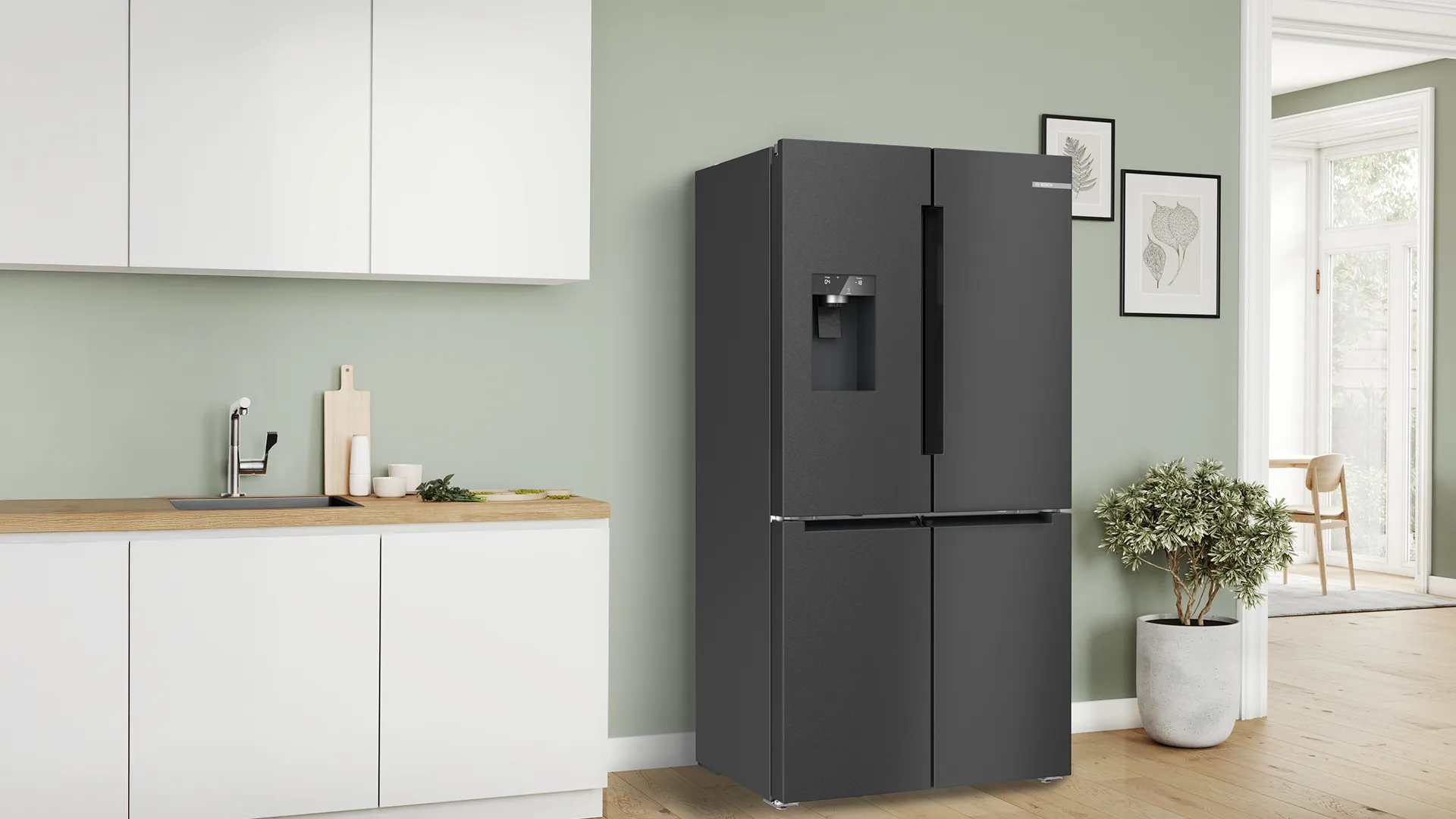 Modern open kitchen with freestanding french door fridge in the corner.