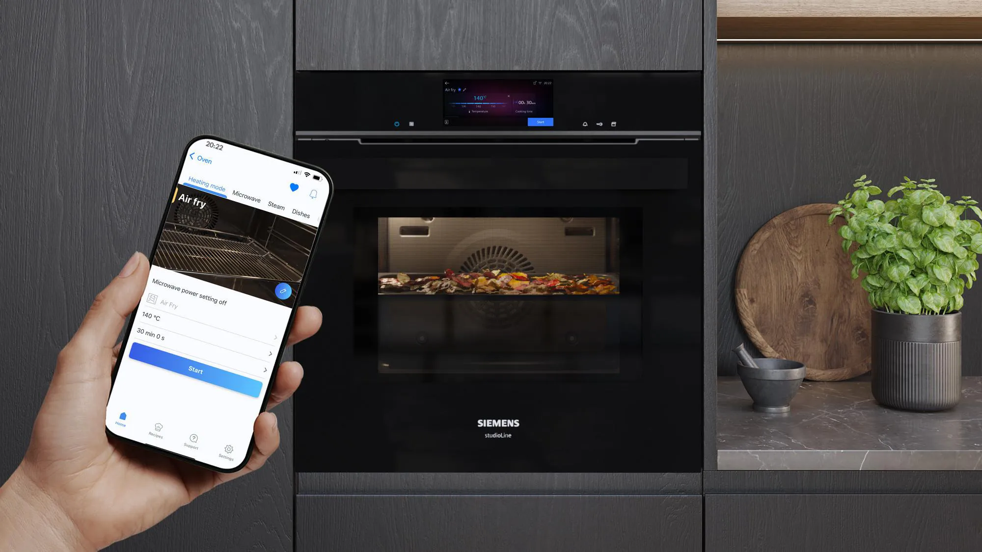 Person using app to control smart oven