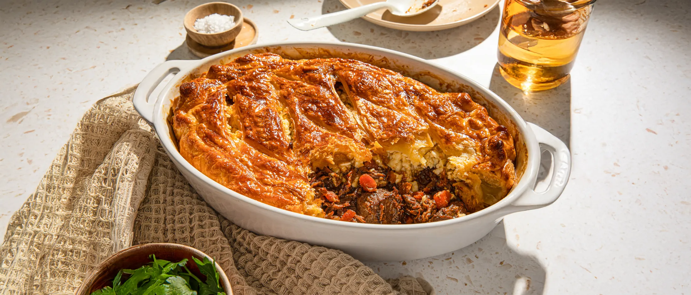 Baked casserole dish with savory meat, vegetables, and a golden-brown crust.