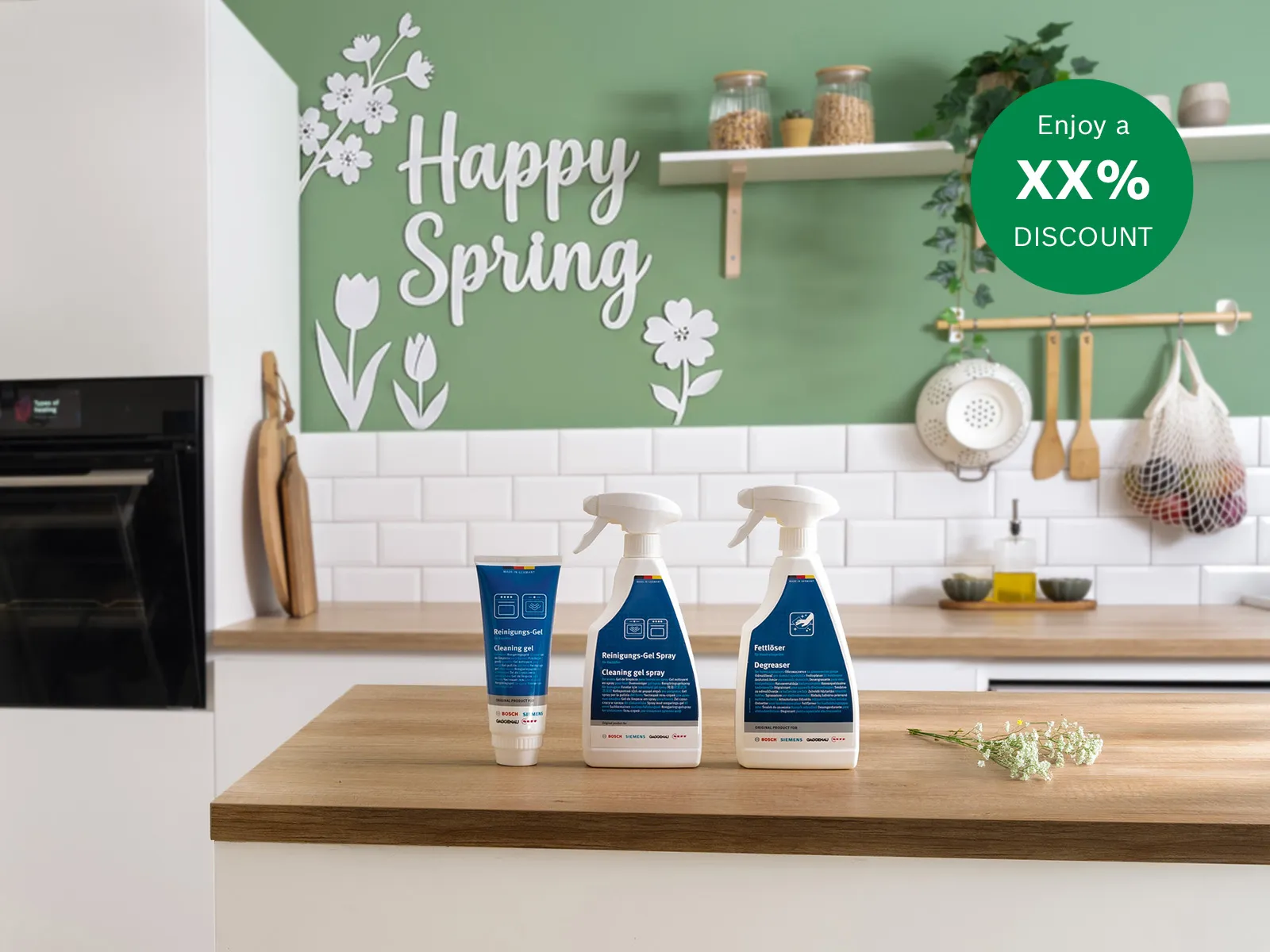 Bright kitchen scene with cleaning products on a wooden counter, "Happy Spring" text, and a discount offer on a green wall.