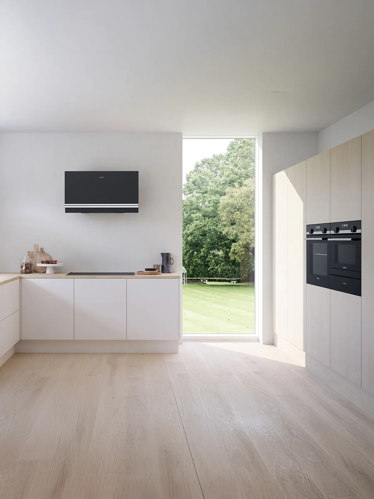Modern kitchen with white cabinets, wooden countertops, and large windows overlooking a grassy outdoor area.