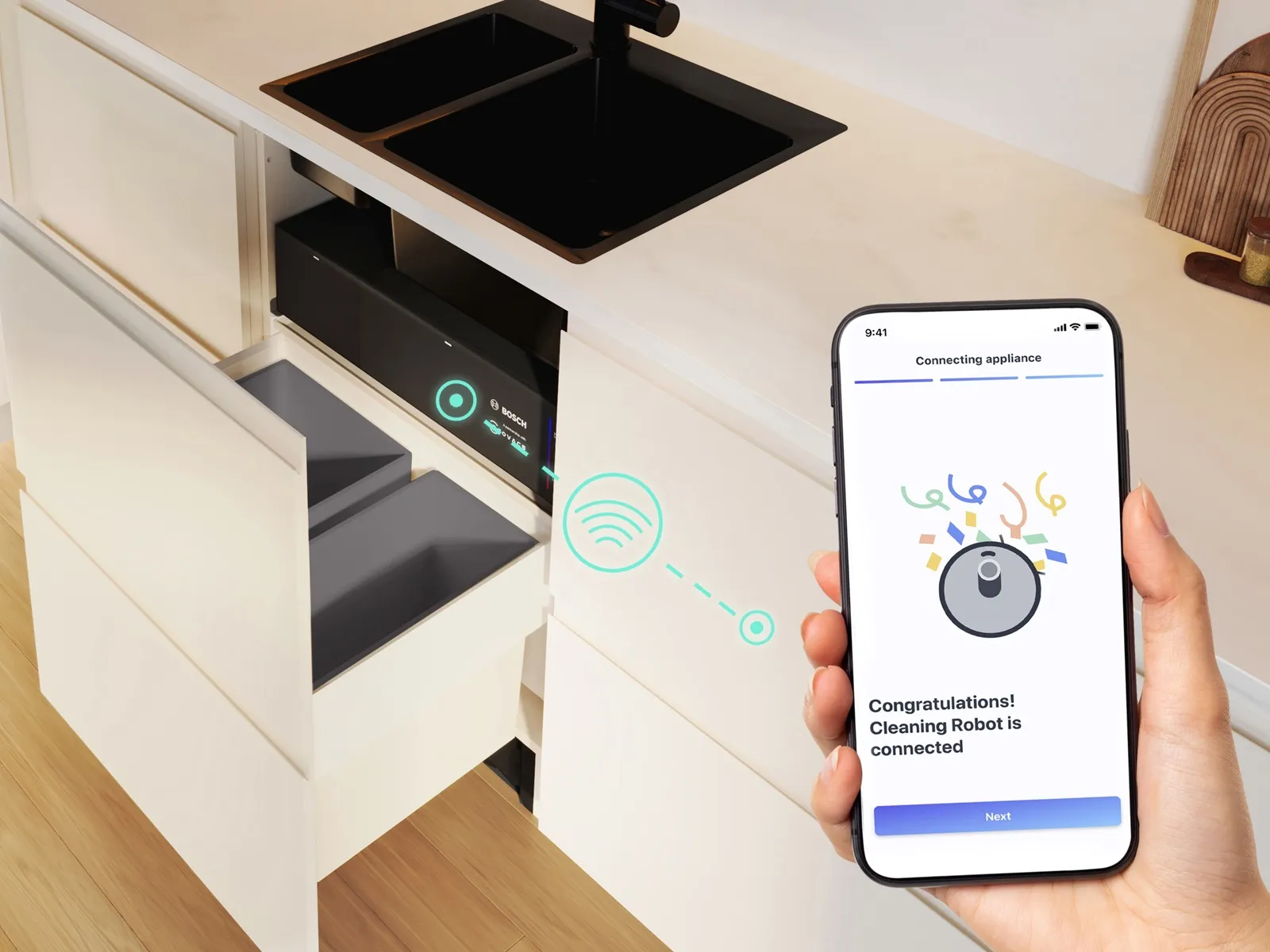 Une visualisation des connexions du nouveau robot aspirateur et laveur encastré Bosch dans une cuisine équipée blanche.