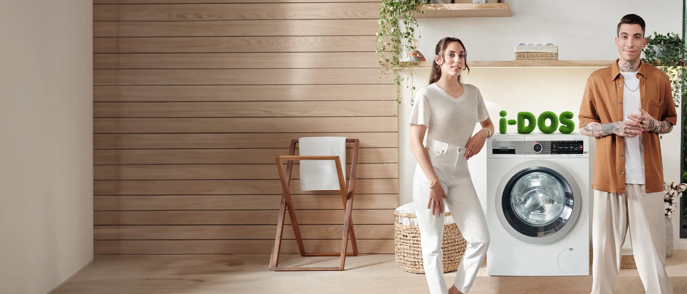 Bosch freestanding washer next to condense dryer in a modern laundry room.