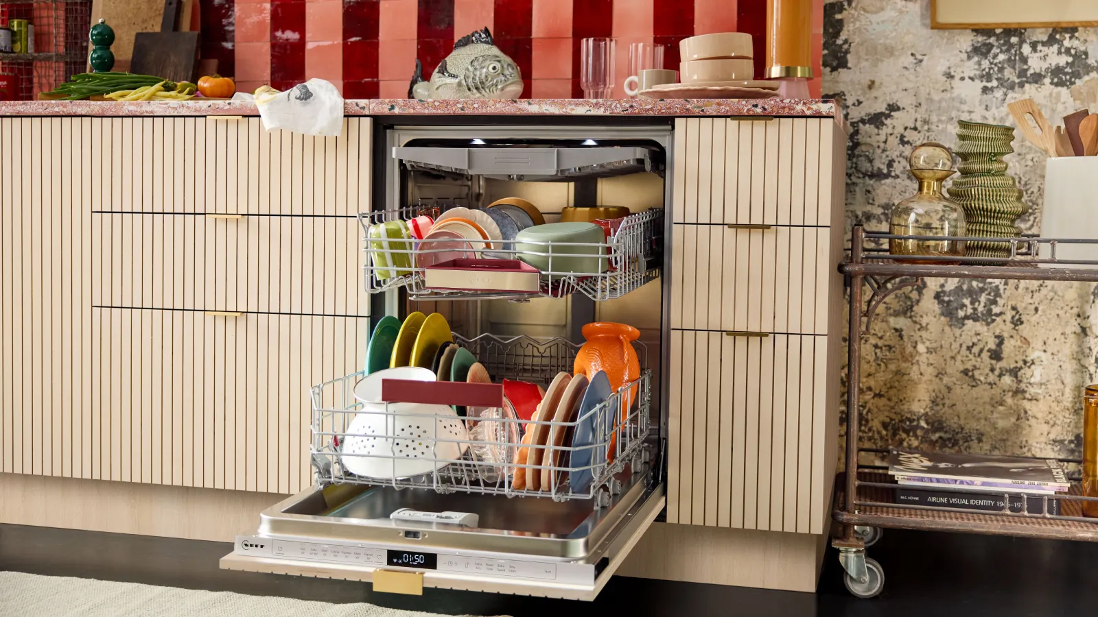 A woman loading dishes into a dishwasher.