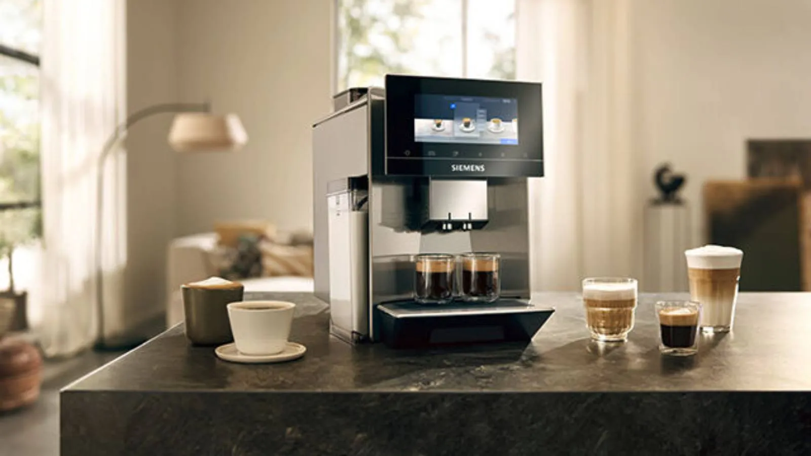 Freestanding coffee machine on kitchen counter with mugs full of different coffees