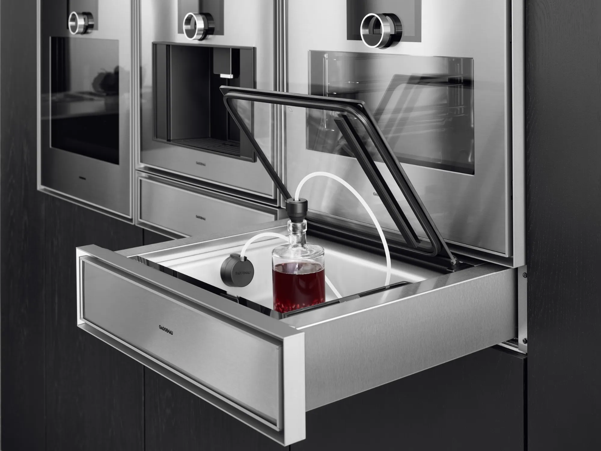 An open Gaggenau Expressive series vacuuming drawer being used to prolong an opened bottle of wine