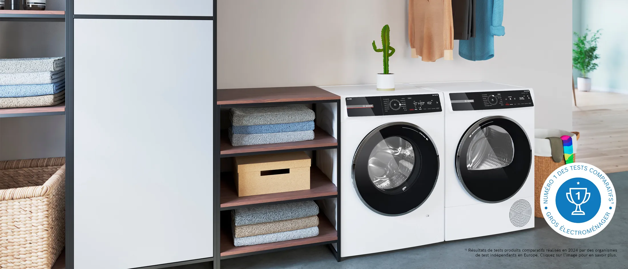 Un lave-linge Bosch en pose libre à côté d'un sèche-linge à condensation dans une salle de lavage moderne.