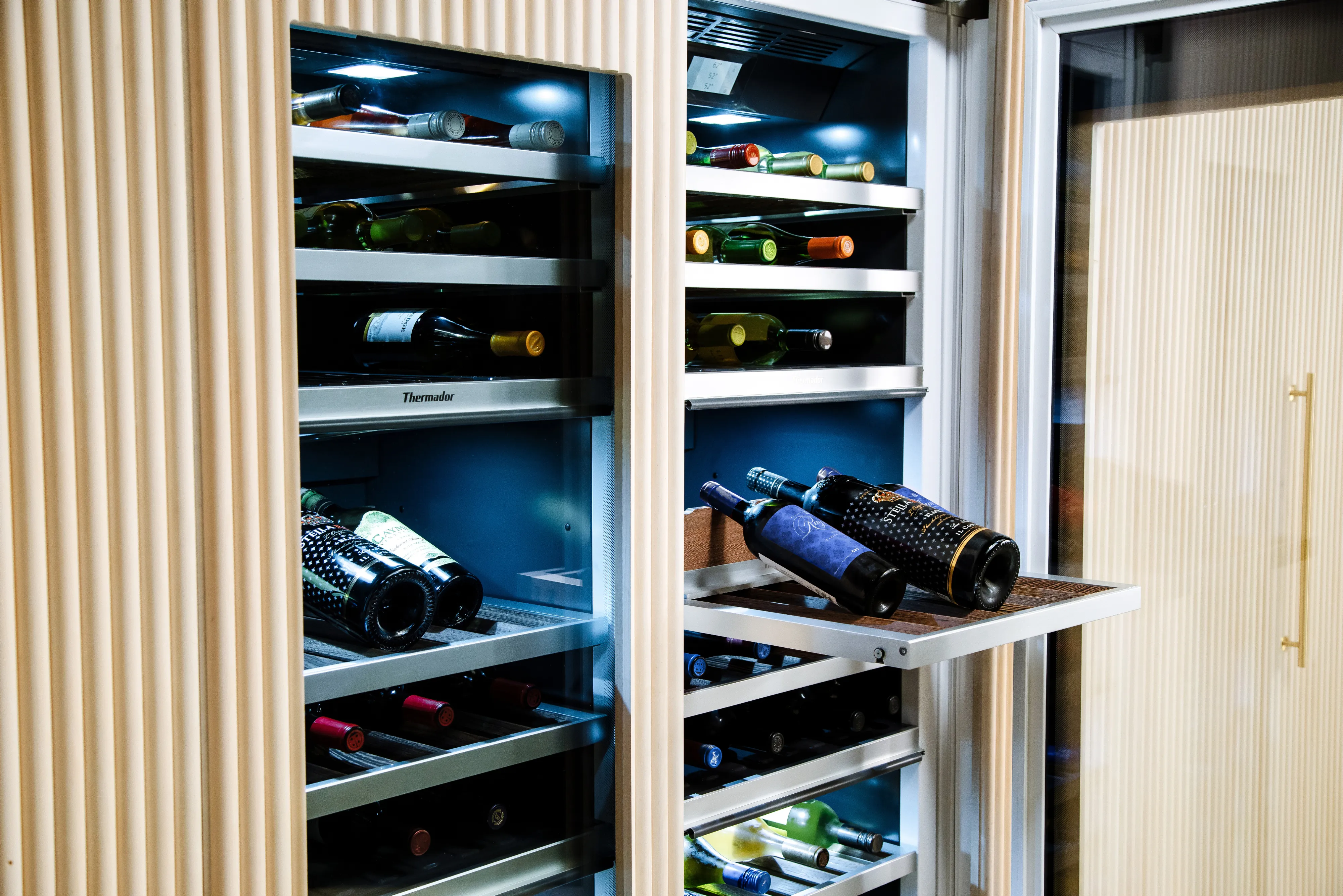 Several bottles of wine inside a wine refrigerator