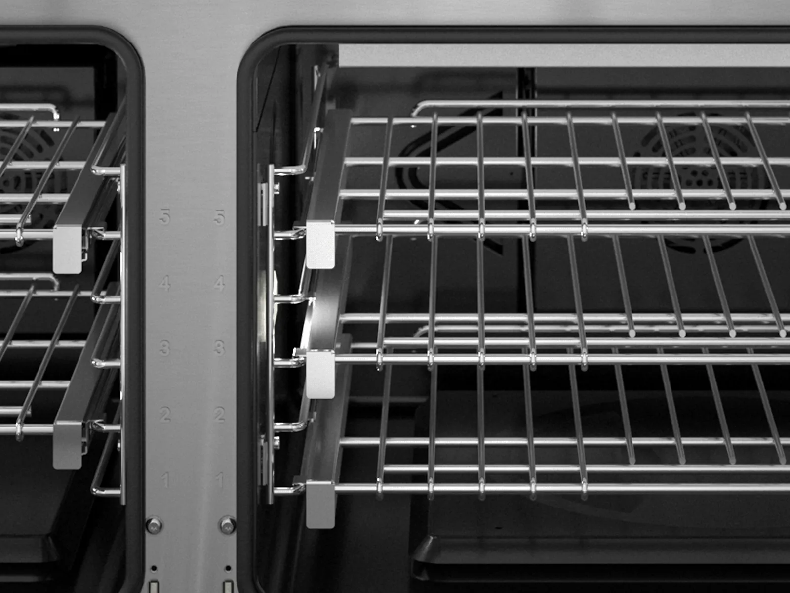 Black and white photo of empty metal wire shelves inside a cabinet or oven.