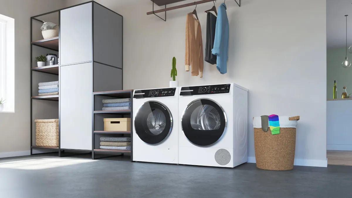 A laundry room featuring a clothing rack with hanging shirts, a pair of white washer and dryer.