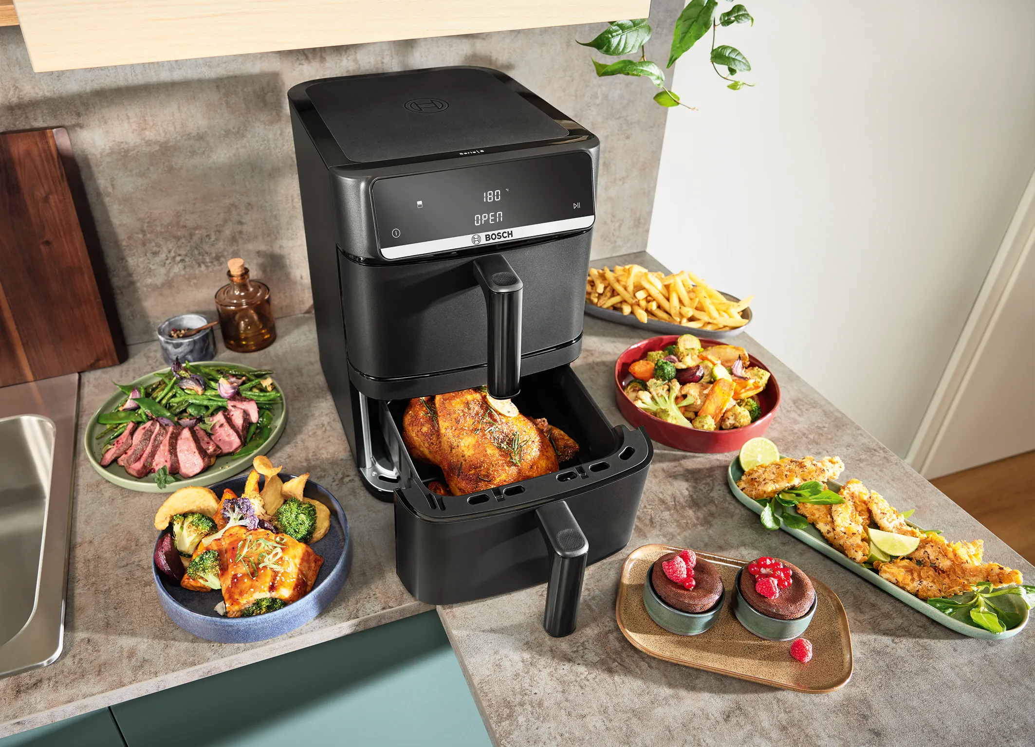 Air fryer with open drawer showing cooked whole chicken