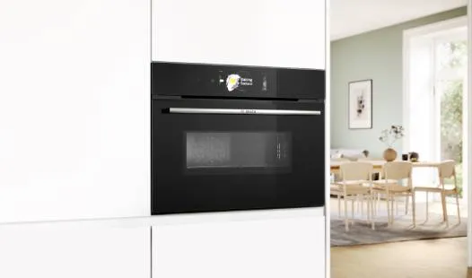 A sleek Bosch built-in oven with a stainless steel front, digital controls, and a black glass oven door.