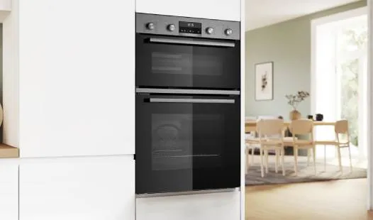 A sleek, modern double oven with a black finish and stainless steel accents, featuring intuitive controls and a digital display.