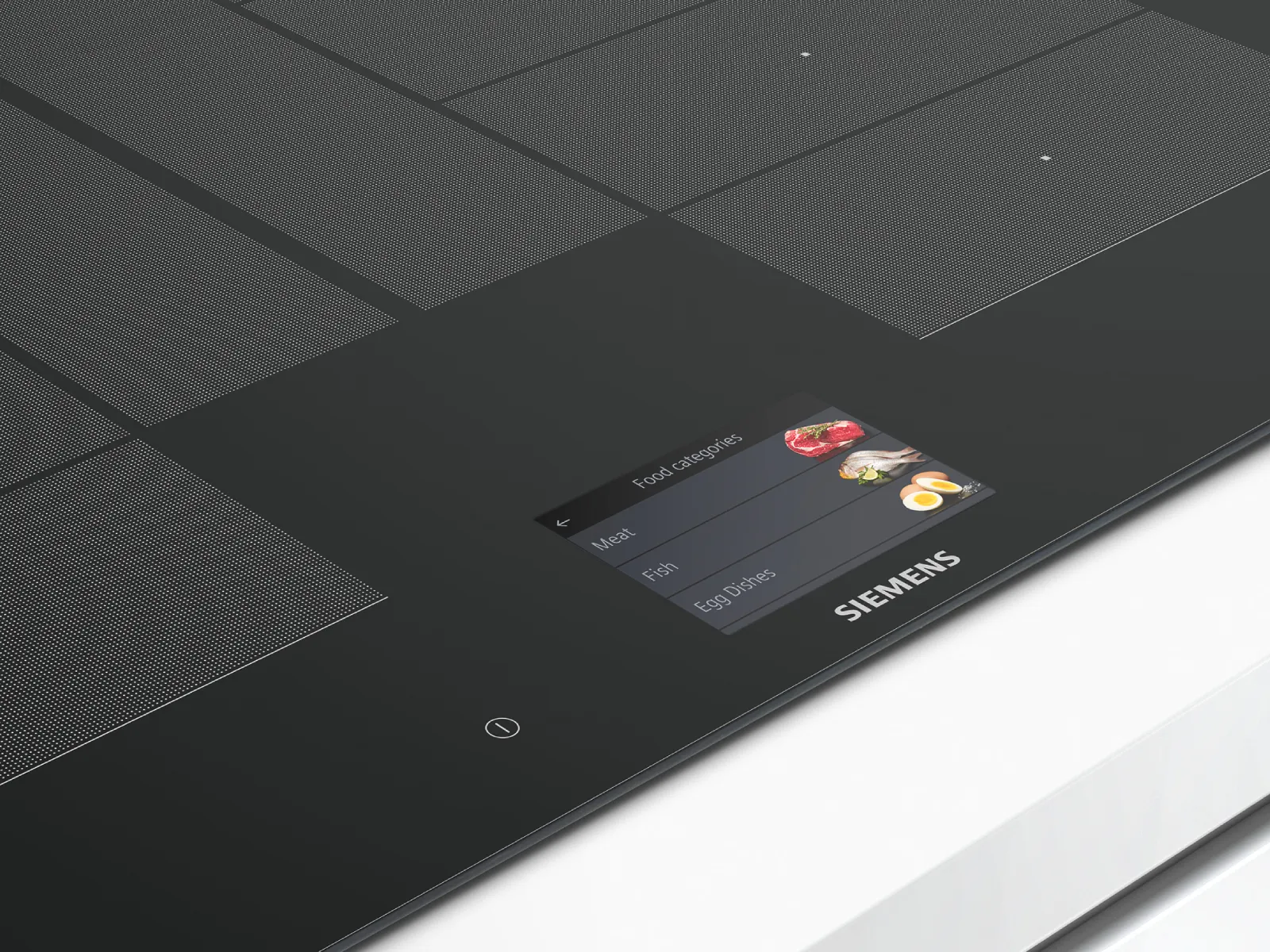 Piano cottura in vetro nero con logo Siemens e pannello di controllo.
