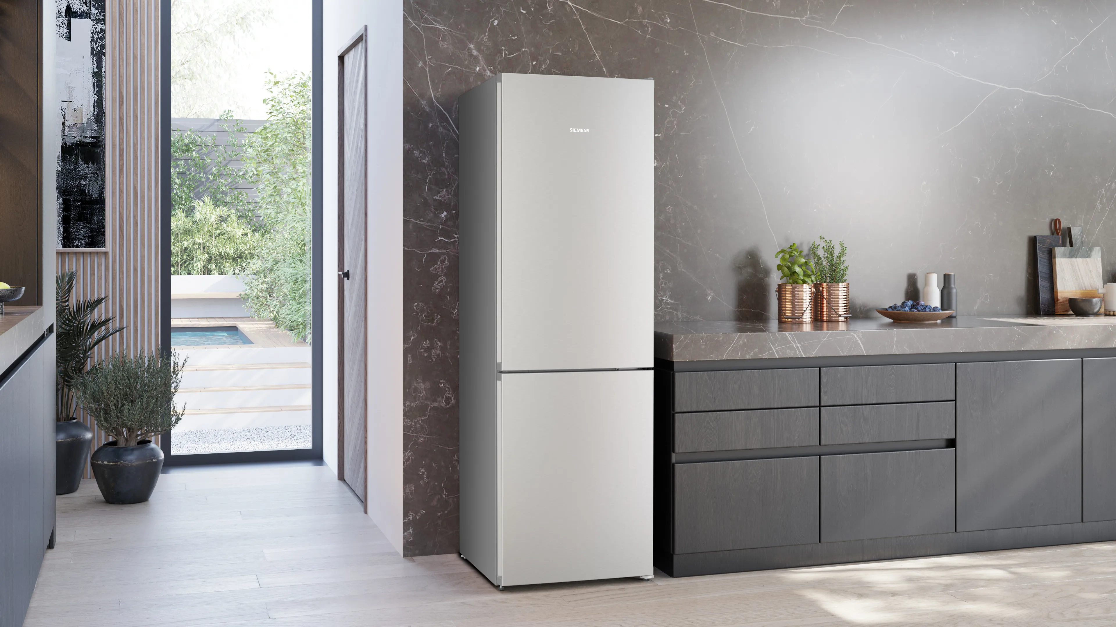 Modern black refrigerator in minimalist room.