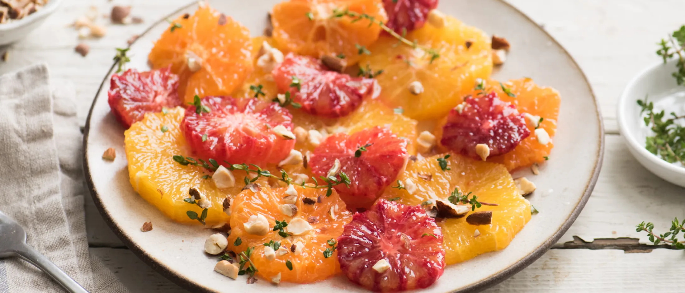 Colorful citrus fruit salad with grapefruit, orange, and pomegranate seeds on a white plate
