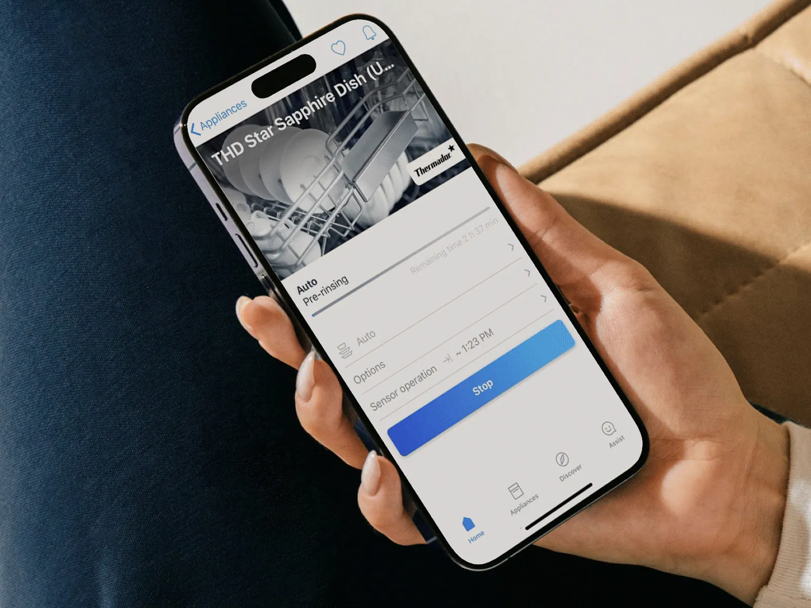 Hand holding a smartphone displaying a service booking screen in a mobile app.