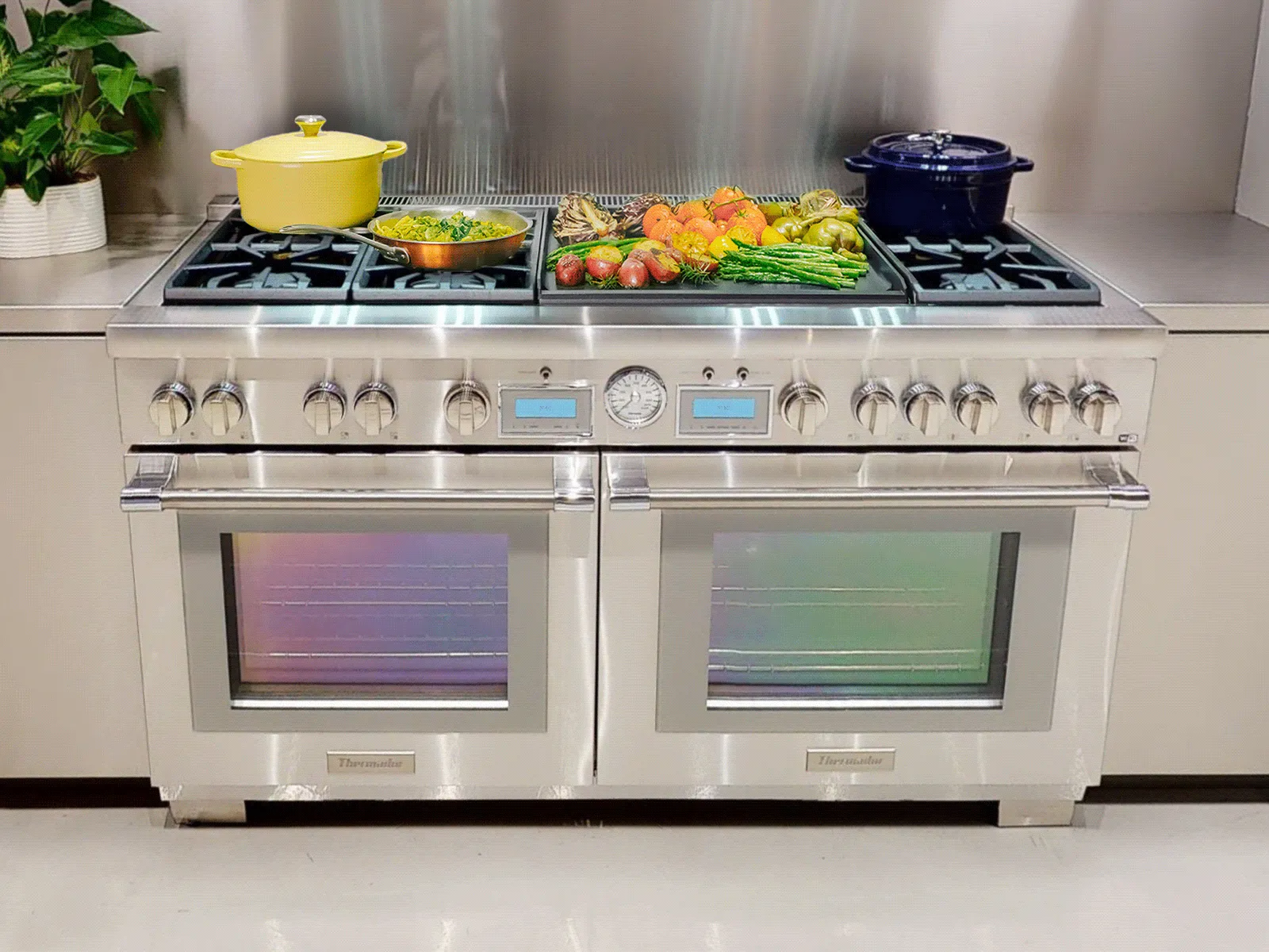 A stainless steel range with two ovens and a stovetop with various dishes cooking.