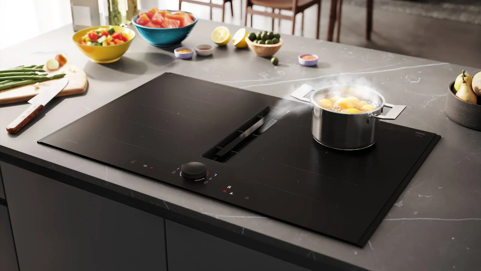 A sleek induction cooktop with an integrated ventilation system is shown with a pot of boiling potatoes steaming. In the background, there are bowls of fresh salad and other ingredients on a modern kitchen island.