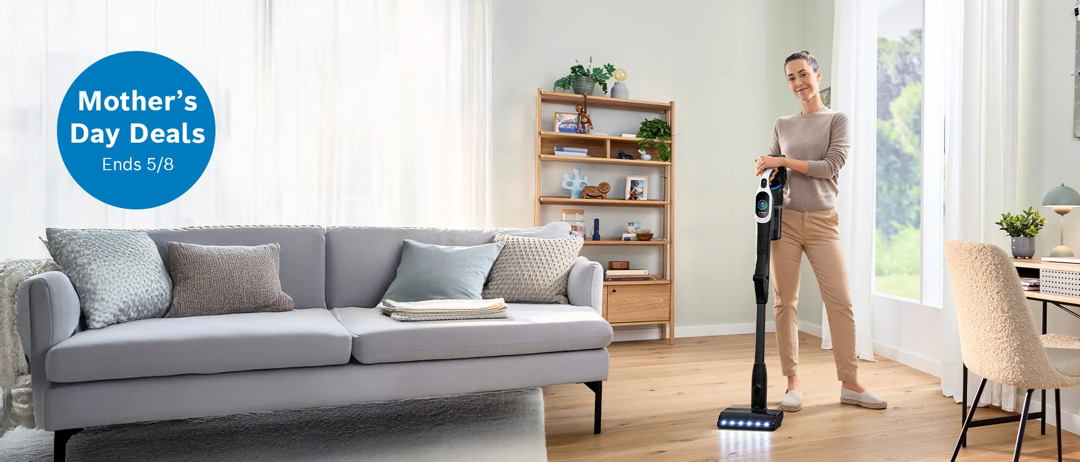 Woman cleaning her living room with bosch stick vacuum 