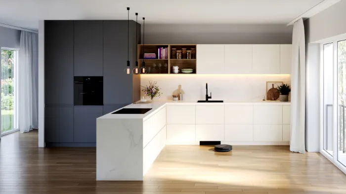 A wide-angle view of a modern, minimalist kitchen with a Bosch robot vacuum cleaning the sunlit wooden floor.