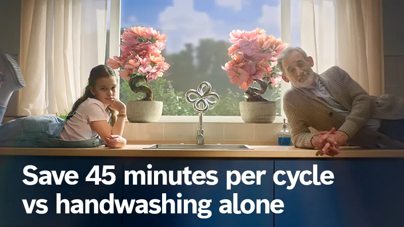 Dad and daughter sat on counter above dishwasher