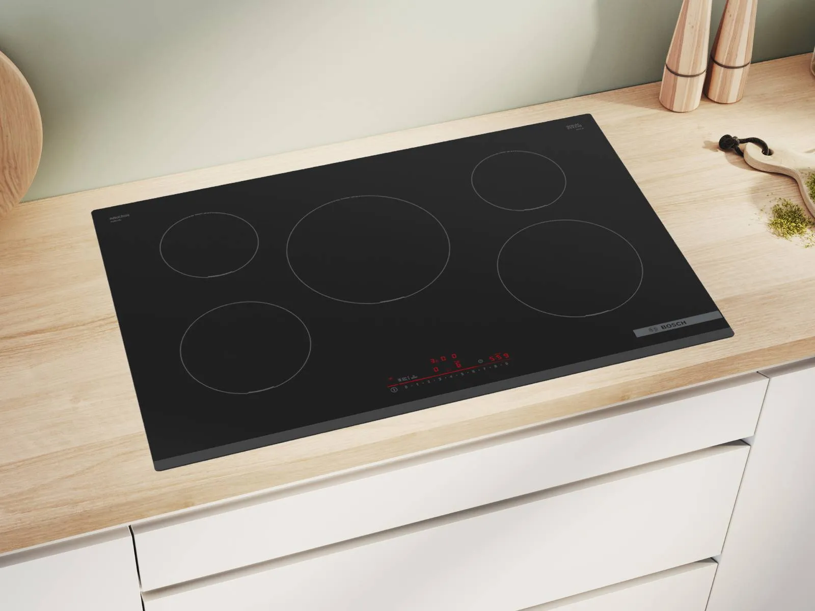 Sleek black induction cooktop on white kitchen counter, modern appliance design.