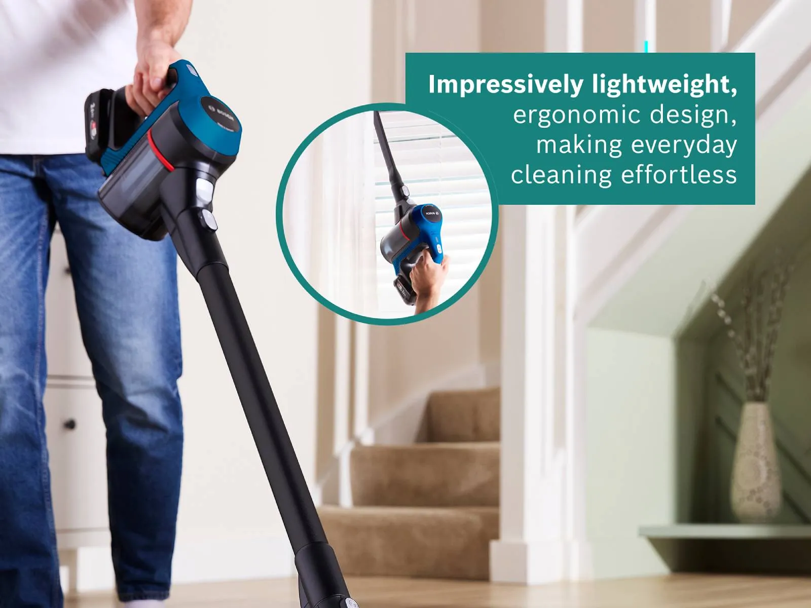 A person vacuums dirt on a wooden floor with a lightweight Bosch cordless vacuum cleaner, highlighting its ergonomic design and ease of use.