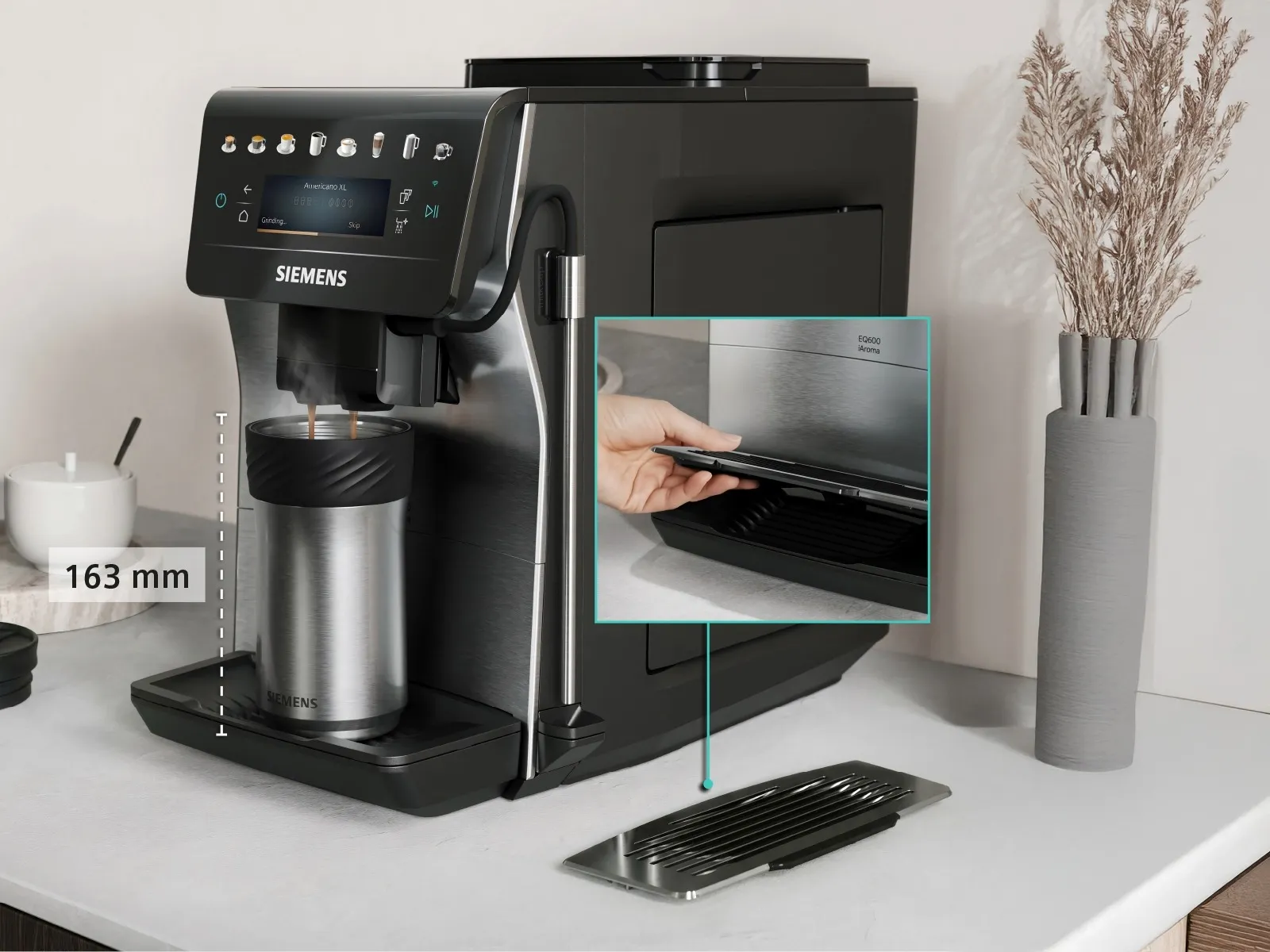 The EQ600 iAroma stands on a kitchen counter with a tall travel mug under it and the XL Flap placed next to the machine.