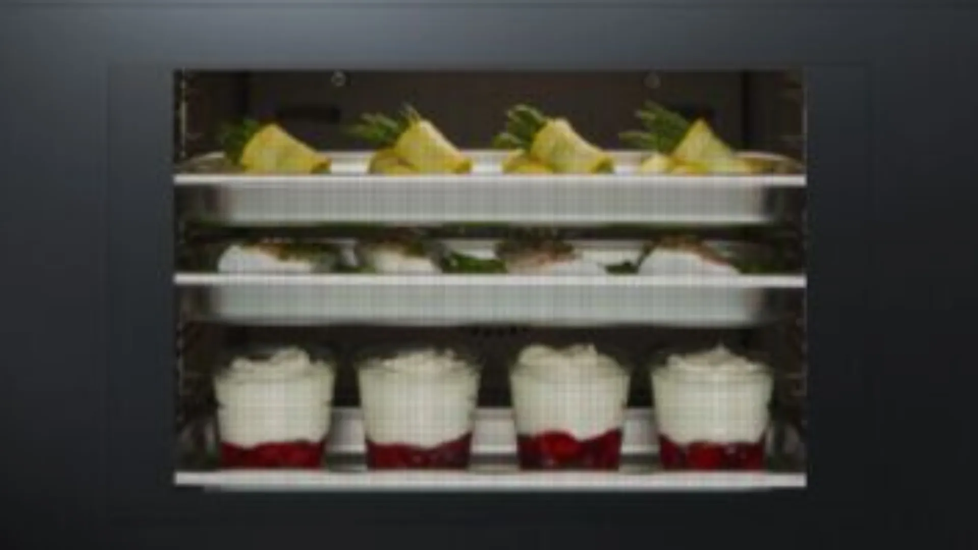 Different types of food cooking in an oven at the same time