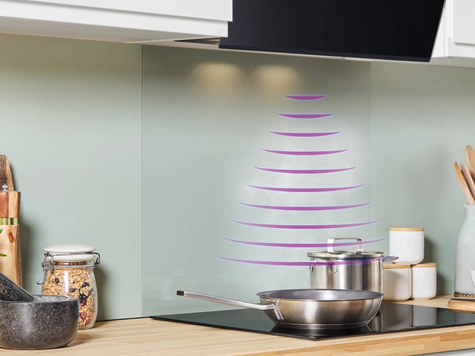 Modern kitchen with induction cooktop, stainless steel pot, and wooden cabinets.
