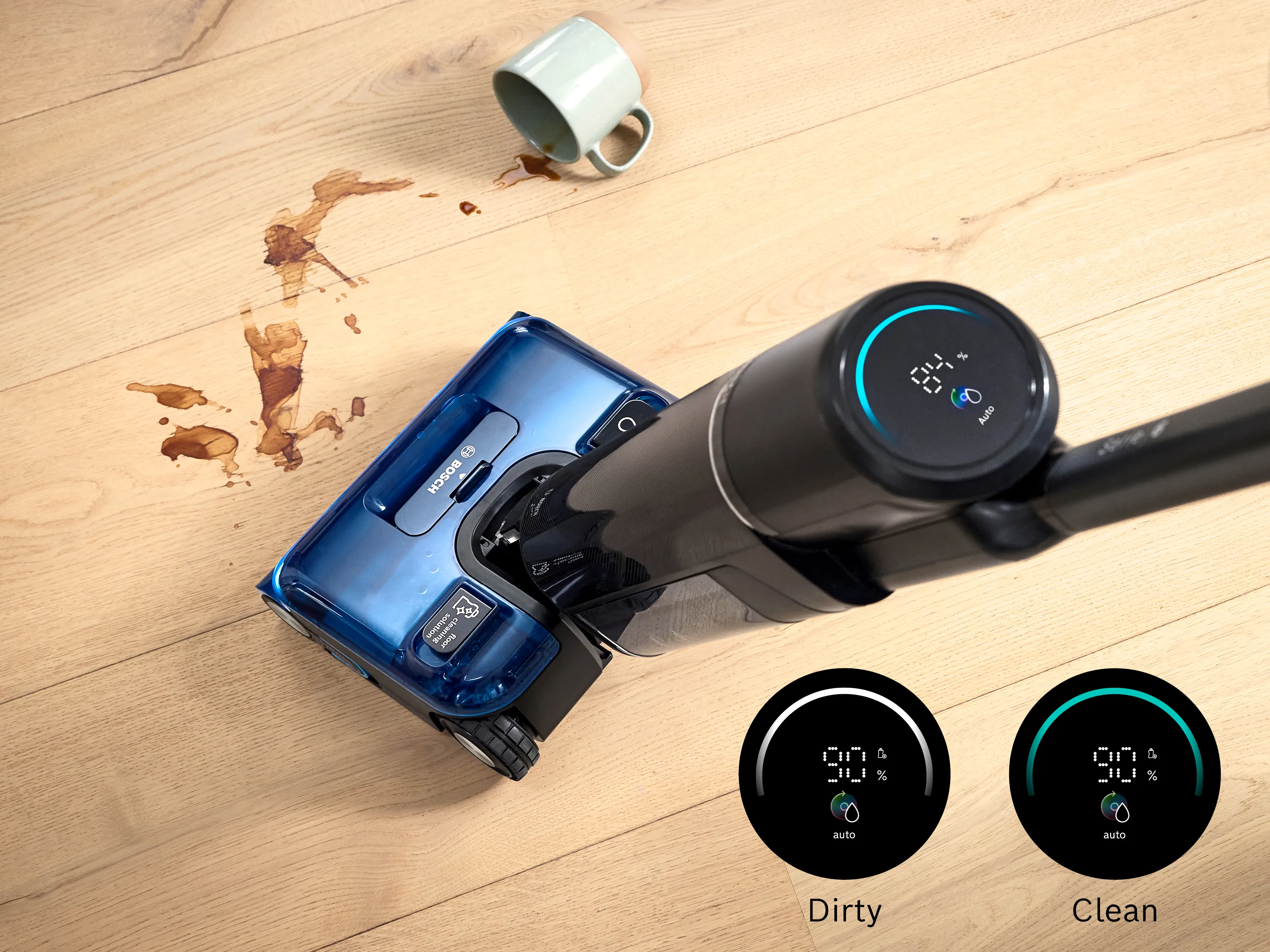 The Bosch Floor Washer is being used to clean up a coffee spill as seen from above, showing the MicroClean Ring function on the appliance.