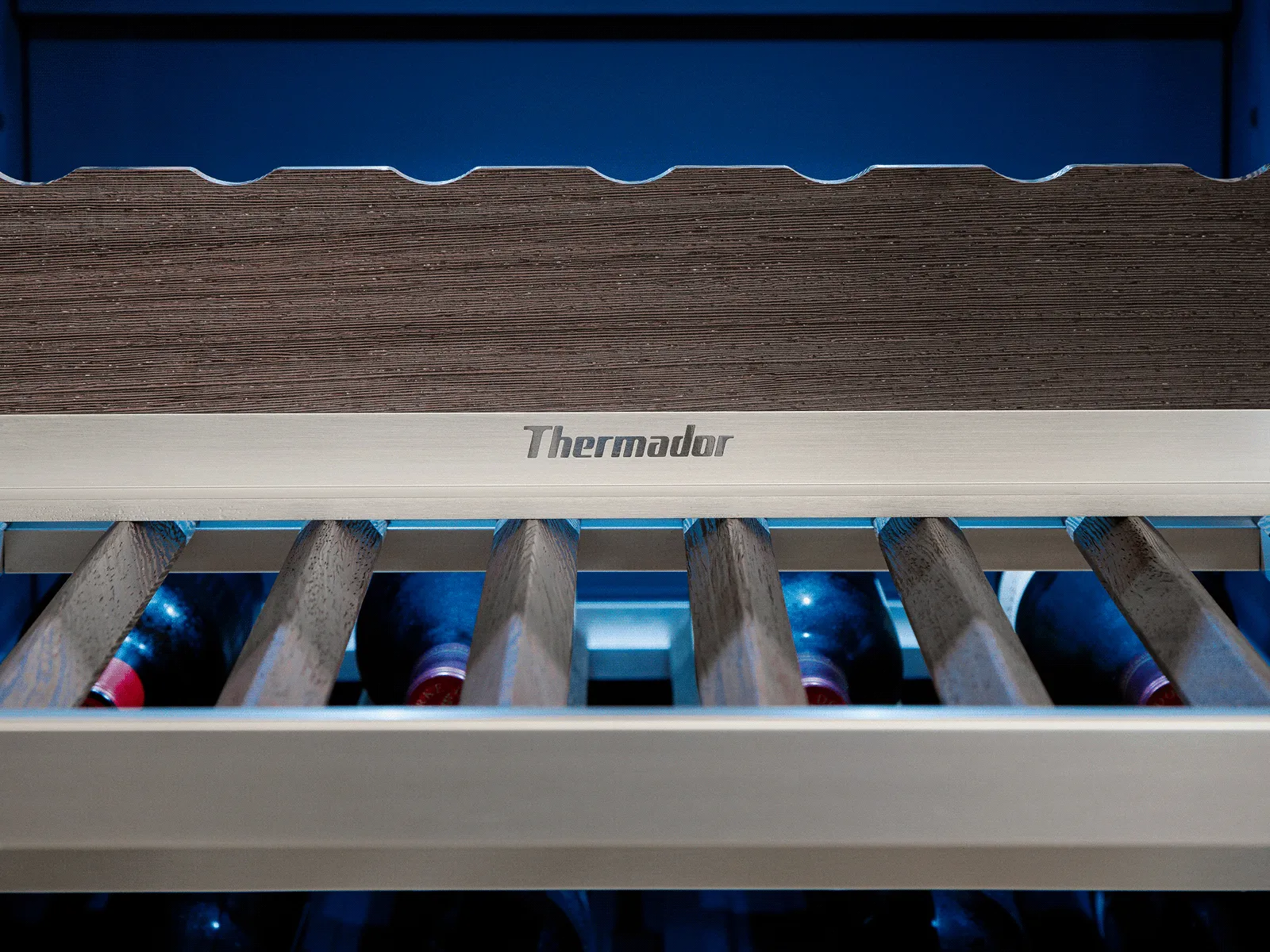 Roller conveyor inside a Thermador appliance, designed for easy loading and unloading of cookware or food trays.