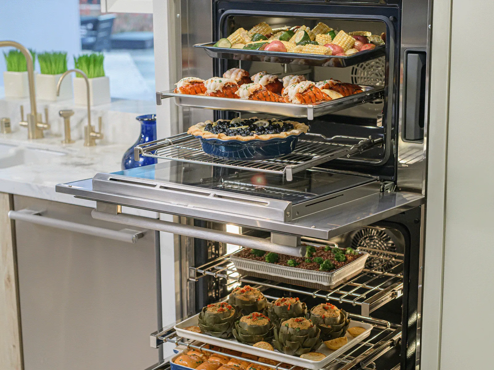 Open oven with multiple racks of food including lobster, pie, vegetables, and stuffed artichokes.