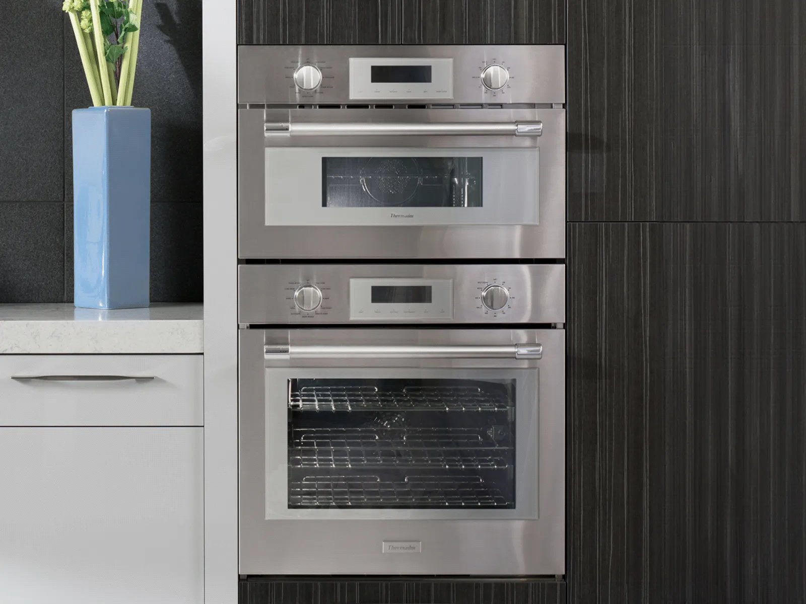 Thermador double wall oven with a microwave on top, sleek modern kitchen.