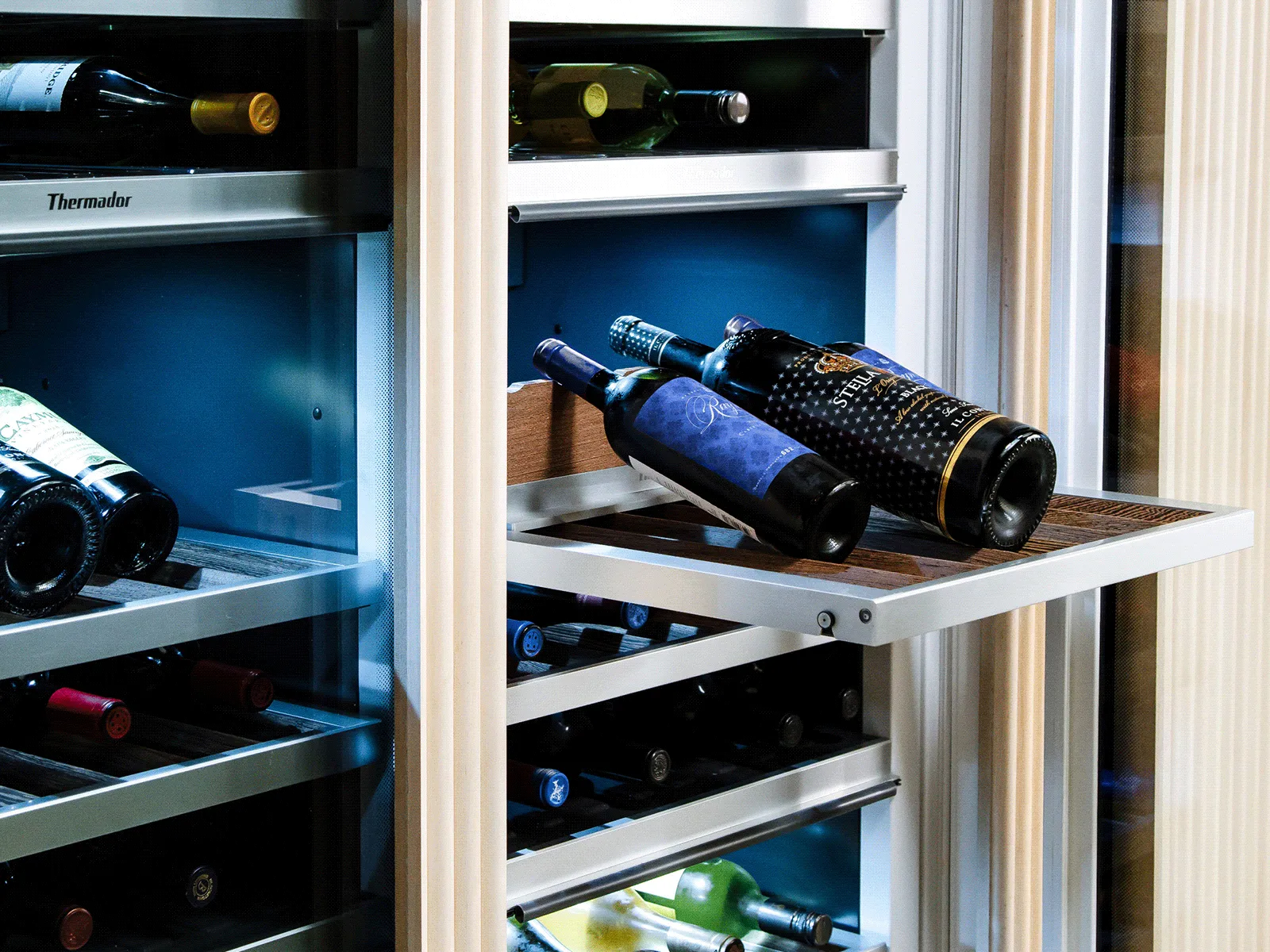 Several bottles of wine inside a wine refrigerator