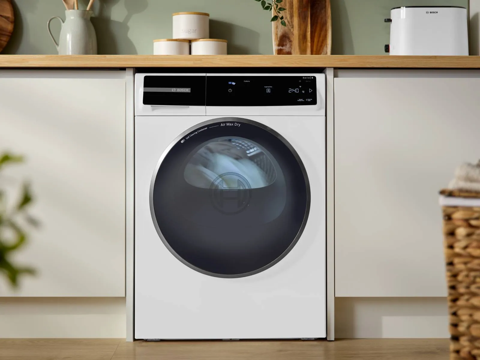 Laundry room with dryer, shelves, and storage containers. Minimalist, organized, and functional design.