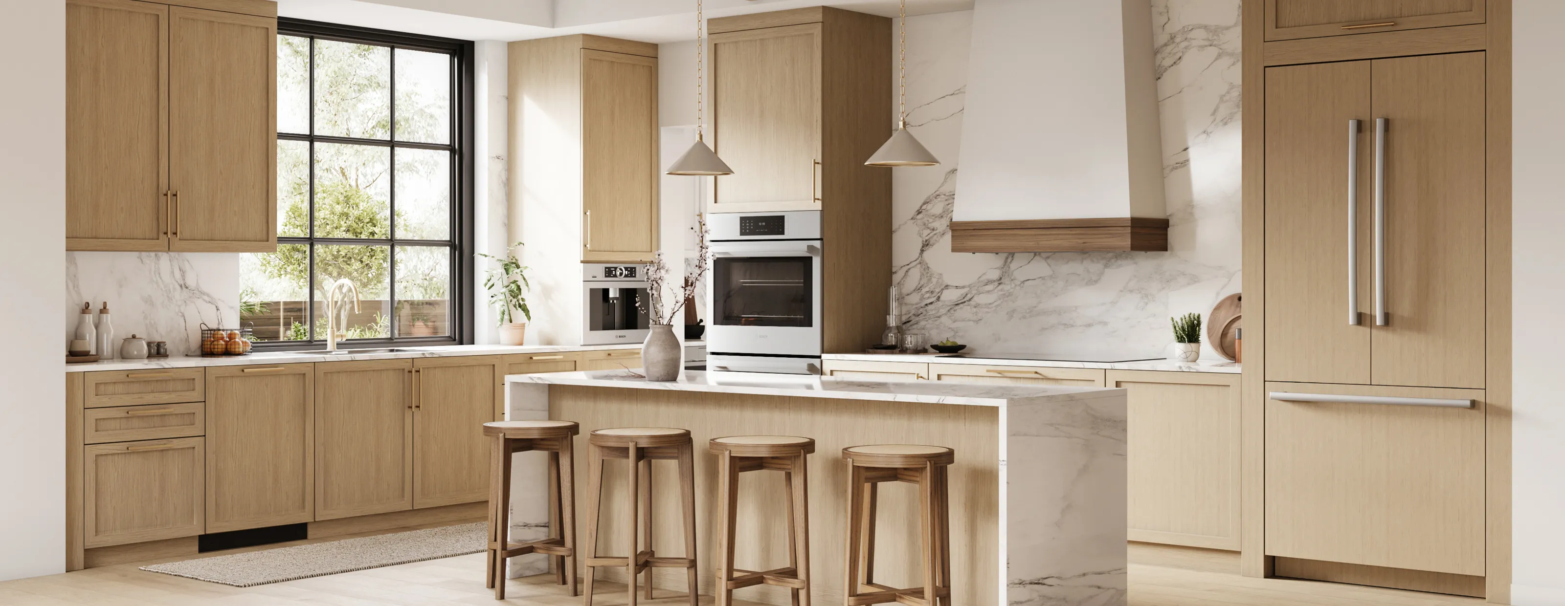 Modern kitchen with light wood cabinets, marble countertops, and Bosch stainless steel appliances.
