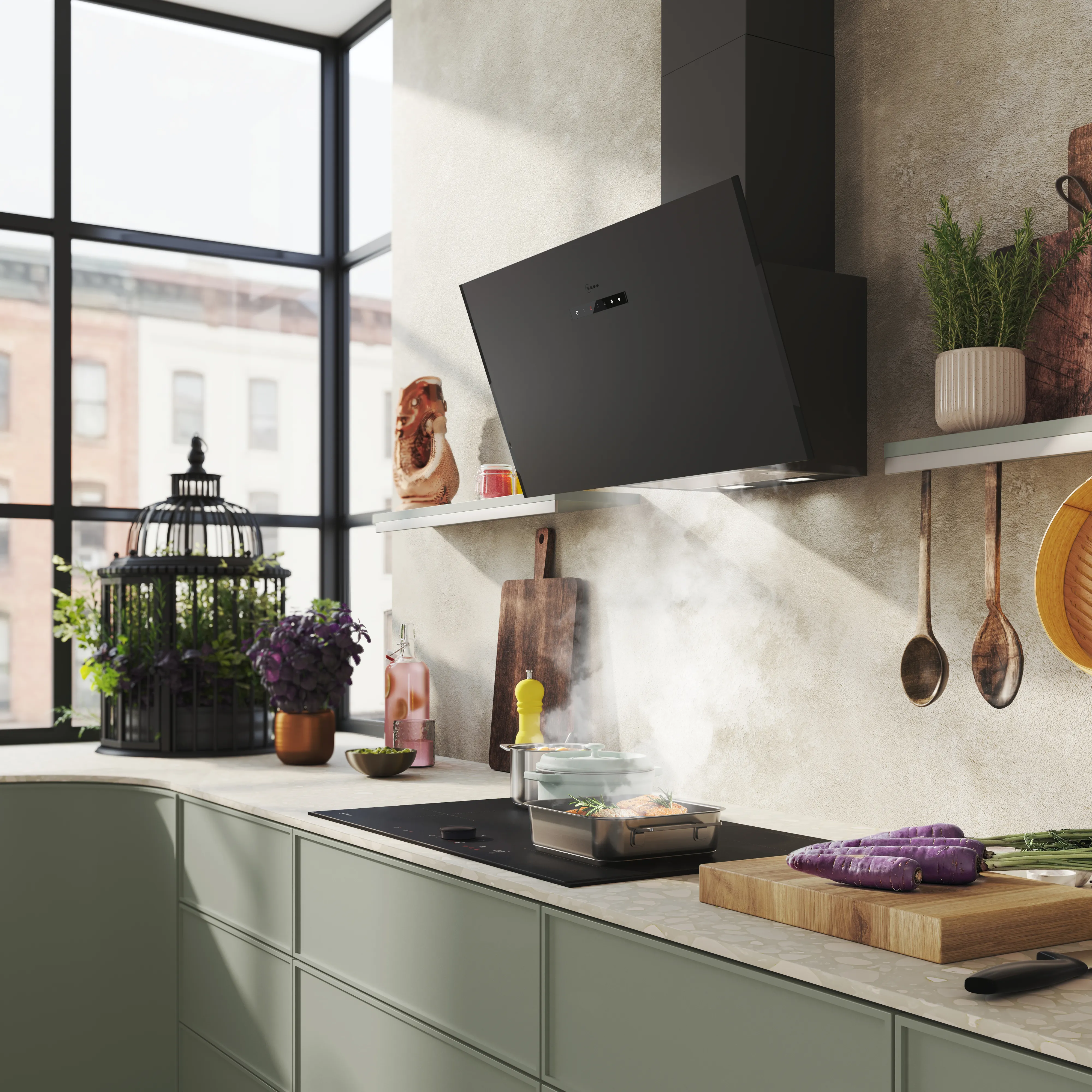 Modern kitchen with black range hood, stovetop cooking with steam, green cabinets, large window, and utensils on shelves.
